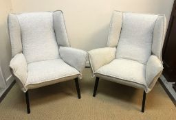 A pair of Ligne Roset "TOA" wing back armchairs on