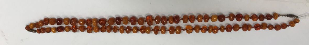 Two lengths of amber beads (can be made into two short necklaces or one long necklace) approx. 57 g