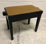 A modern Italian black lacquered adjustable piano stool of plain form raised on square supports 62.5