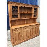 A modern pine dresser, the plate rack with two leaded glazed doors over four drawers and four twin