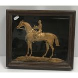 A framed and glazed gilt brass and engraved cast figure of "Jockey on horseback", 36 cm x 26 cm