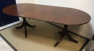 A 19th Century mahogany satinwood strung and cross banded fold over card table raised on square