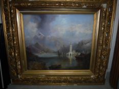 A CONTINENTAL SCHOOL "Mountainous lake scene with buildings and boats in foreground" oil on