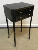 A 19th Century black lacquered and gilt decorated work table, the rising top opening to reveal a