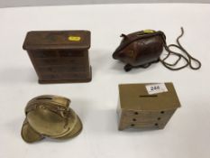 A collection of four novelty money boxes including one as a fireman's helmet, another as a brass