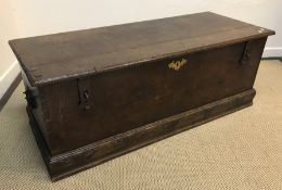 An 18th Century oak coffer the two plank top with cleated ends and moulded edge over plain front and