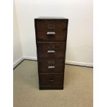 A vintage stained pine four drawer filing cabinet 45.5cm wide x 66cm deep x 127cm high