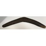 A vintage Aboriginal boomerang with carved and painted decoration of six kangeroos in the bush 78 cm