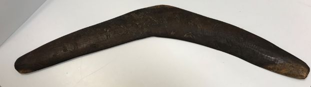 A vintage Aboriginal boomerang with carved and painted decoration of six kangeroos in the bush 78 cm