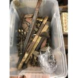 A plastic crate containing a quantity of various sword and dagger scabbards and accessories