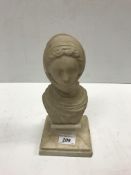 A late 19th/early 20th Century carved marble bust of "woman in headscarf" on a square spreading