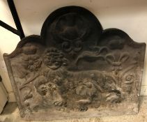 A cast iron fire back decorated with central lion passant and symbols of the Union 77 cm wide x 70