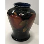 A Moorcroft pomegranate design vase of flared form 19 cm high