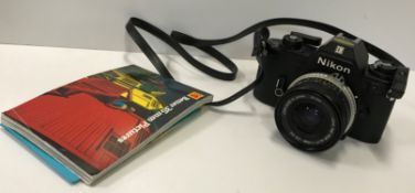 A Nikon EM camera with Hoya HMC wide auto lens and other accessories in a leather mounted canvas