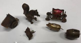A collection of five various gilt brass novelty tape measures including squirrel, carriage,