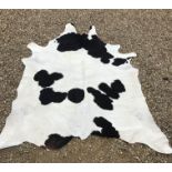 A black and white Cow hide rug (unmounted), approx 240 cm x 223 cm