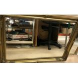 A modern gilt framed mirror with bevelled edge, 105 cm x 75.5 cm, together with another smaller