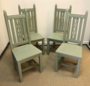 A set of four modern green painted panel-seated hall chairs