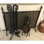 A wrought iron spark guard, 67 cm high x 78 cm wide, together with a companion set, 70 cm high and a