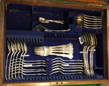 An oak-cased cutlery canteen containing six tablespoons, four table forks, twelve dessert forks, six