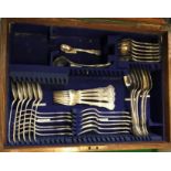 An oak-cased cutlery canteen containing six tablespoons, four table forks, twelve dessert forks, six