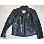 A Star Enterprise black leather motorcycle jacket, size 44"