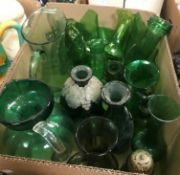 A collection of assorted green glass jugs, vases etc
