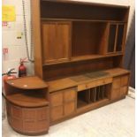 A Nathan teak lounge unit, 183 cm wide x 46 cm deep x 183 cm high, together with two dwarf cabinets,