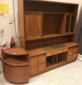 A Nathan teak lounge unit, 183 cm wide x 46 cm deep x 183 cm high, together with two dwarf cabinets,