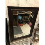 A modern mahogany framed rectangular wall mirror with bevelled edge, 110 cm x 80 cm