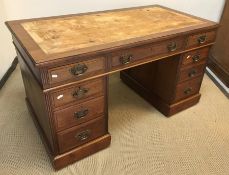 An Edwardian mahogany pedestal desk, the plain top above two banks of four drawers with central