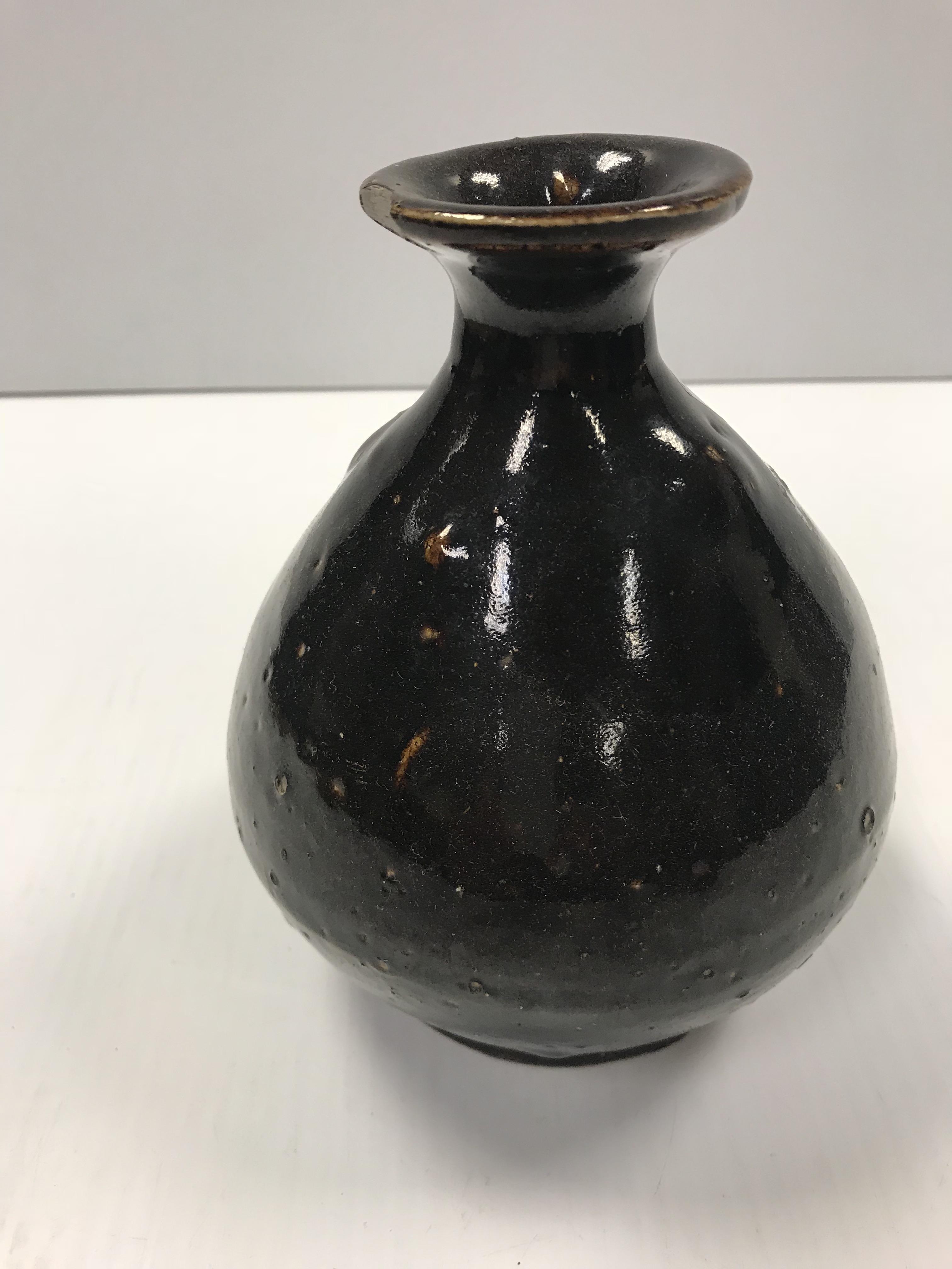 A Chinese treacle glazed vase of bellied form, bea