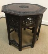 An Indian carved rosewood octagonal occasional table (67 cm diameter x 60 cm H)Condition