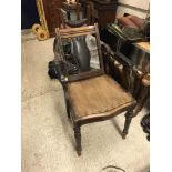 A late Victorian mahogany framed barber's chair with adjustable head rest and back, over a