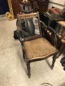 A late Victorian mahogany framed barber's chair with adjustable head rest and back, over a