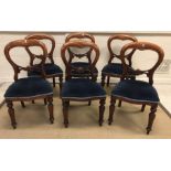 A set of six 20th Century mahogany dining chairs in the Victorian manner with upholstered seats on
