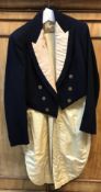 A vintage blue and silk tailed hunt coat with engraved Beaufort Hunt brass buttons.