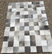 A modern John Lewis Cow hide patchwork rug, approx 240 cm x 170 cm