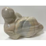 A modern carved marble figure of a recumbent nude,