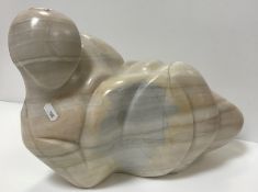 A modern carved marble figure of a recumbent nude,