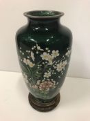 A modern cloisonne baluster vase, the floral decoration on translucent green enamel ground 21 cm