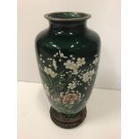 A modern cloisonne baluster vase, the floral decoration on translucent green enamel ground 21 cm