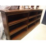 A circa 1900 mahogany open bookcase of three tiers of adjustable shelving, 245 cm wide x 28 cm