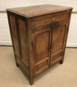 A 19th Century Indian teak cupboard, the plain top above a parquetry inlaid frieze and two