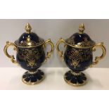 A pair of Coalport bleu royale and gilt decorated twin handled goblets and covers, No'd to base "