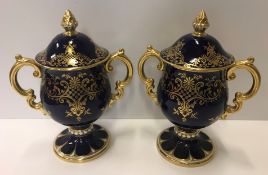 A pair of Coalport bleu royale and gilt decorated twin handled goblets and covers, No'd to base "