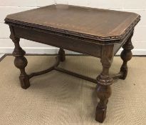 A mid 20th Century oak draw leaf dining table in the 17th Century style, the top with carved edge,