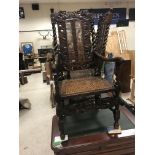 Three walnut framed hall chairs in the Carolean manner with cane seats and backs, carved with
