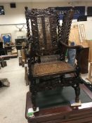 Three walnut framed hall chairs in the Carolean manner with cane seats and backs, carved with