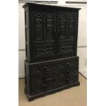 A 19th Century Flemish carved oak cupboard, the two door upper section with figural and angel carved